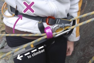 An incorrectly aligned belay plate for top roping. As you can see the body gets in the way of locking the rope off properly, making it extremely likely that you will drop the climber it they fall.